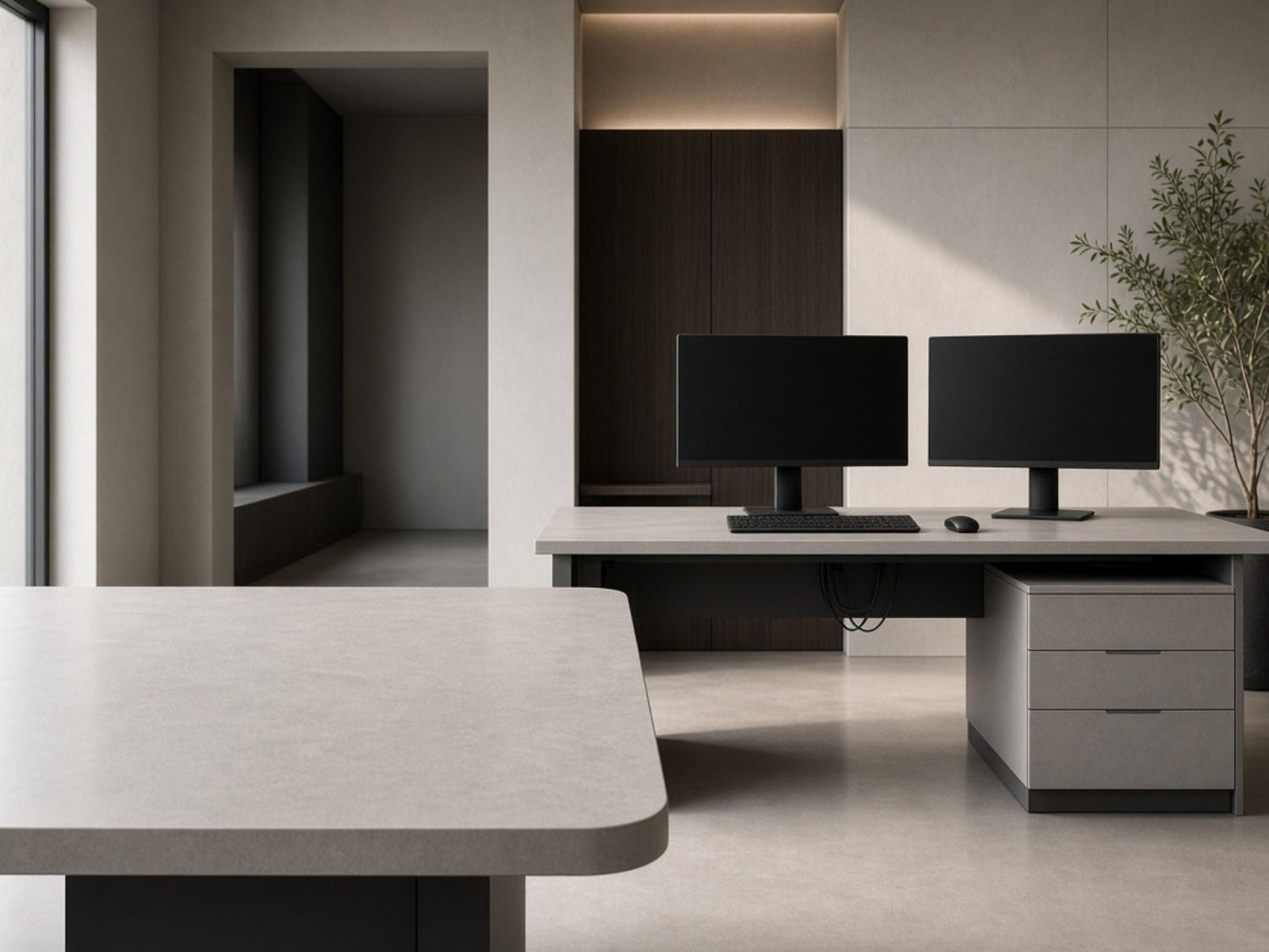 Modern office featuring a computer workstation desk with dual monitors and a large rectangular meeting table